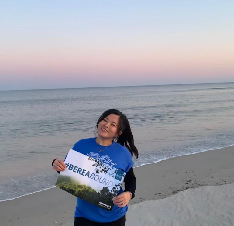madina with her Berea Bound sign at the beach